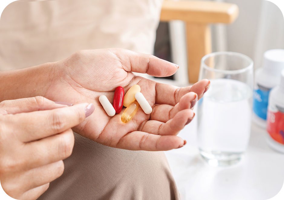 Woman holding probitic pills that support vaginal wellness.