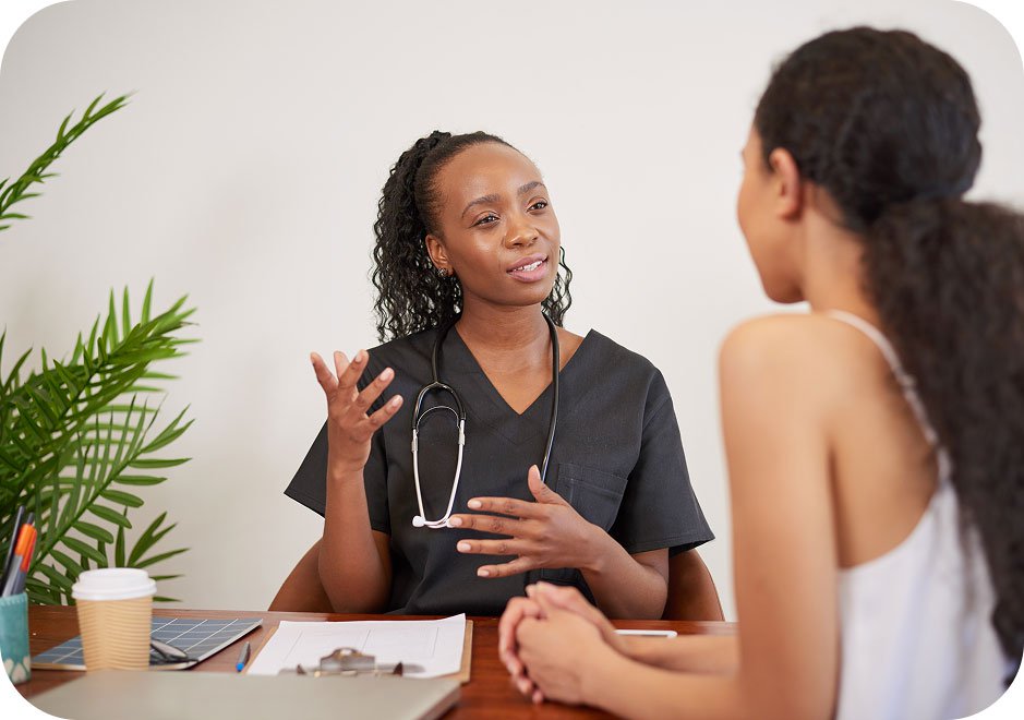 Candid shot of a female doctor explaining the difference between yeast infections and bacterial vaginosis (BV) to a patient during a consultation.